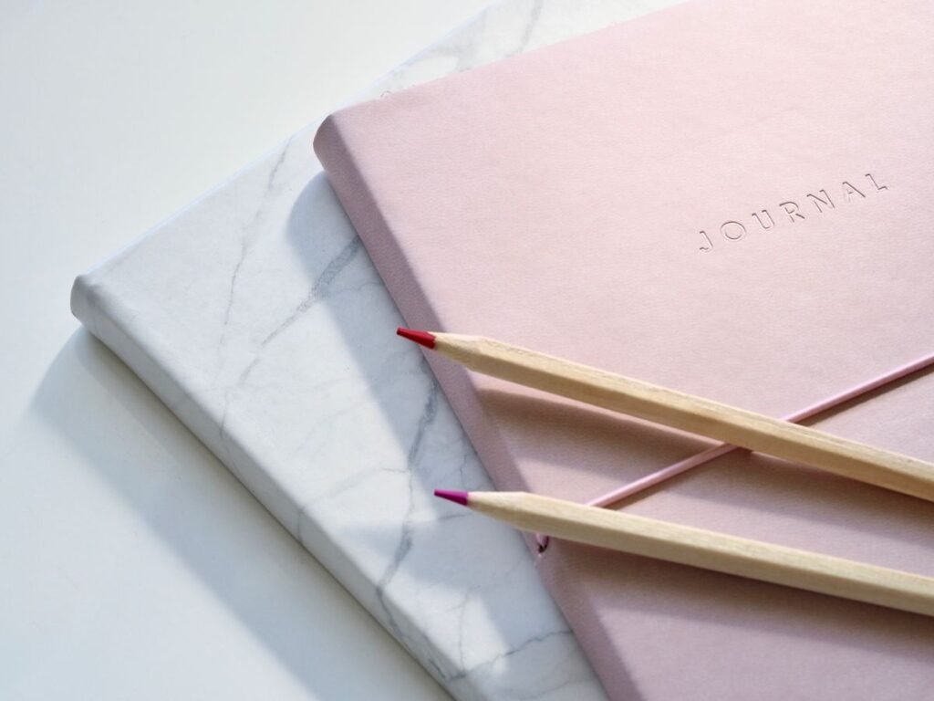 Close-up of a journal book with pencils
