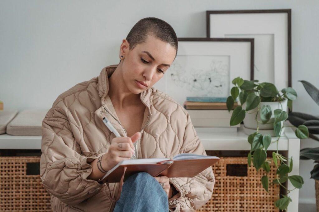 Woman thoughtfully writing reflections in a journal