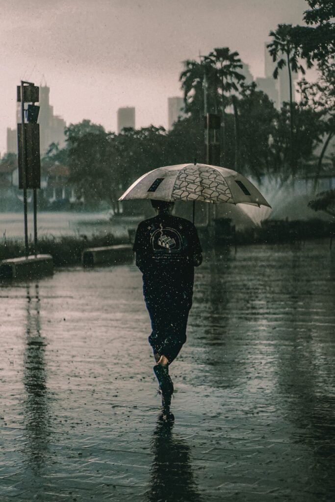 Person under an umbrella in heavy rain