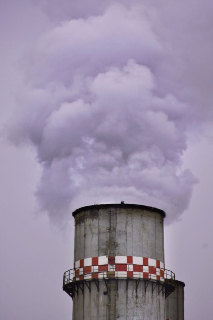 Factory chimney producing smoke causing air pollution