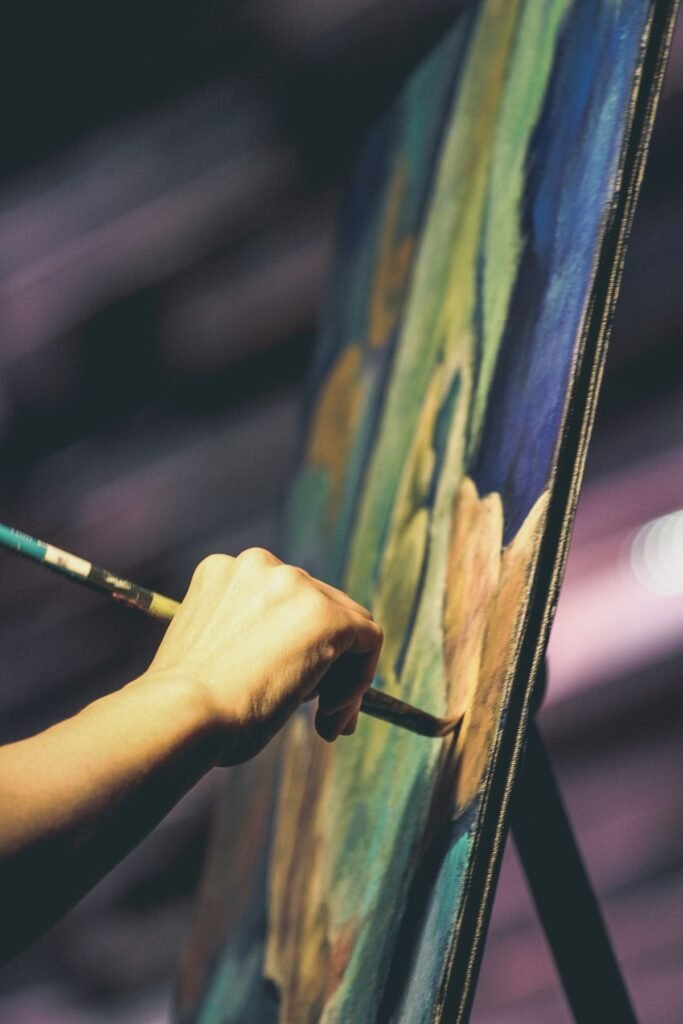 Person painting on a canvas as a hobby