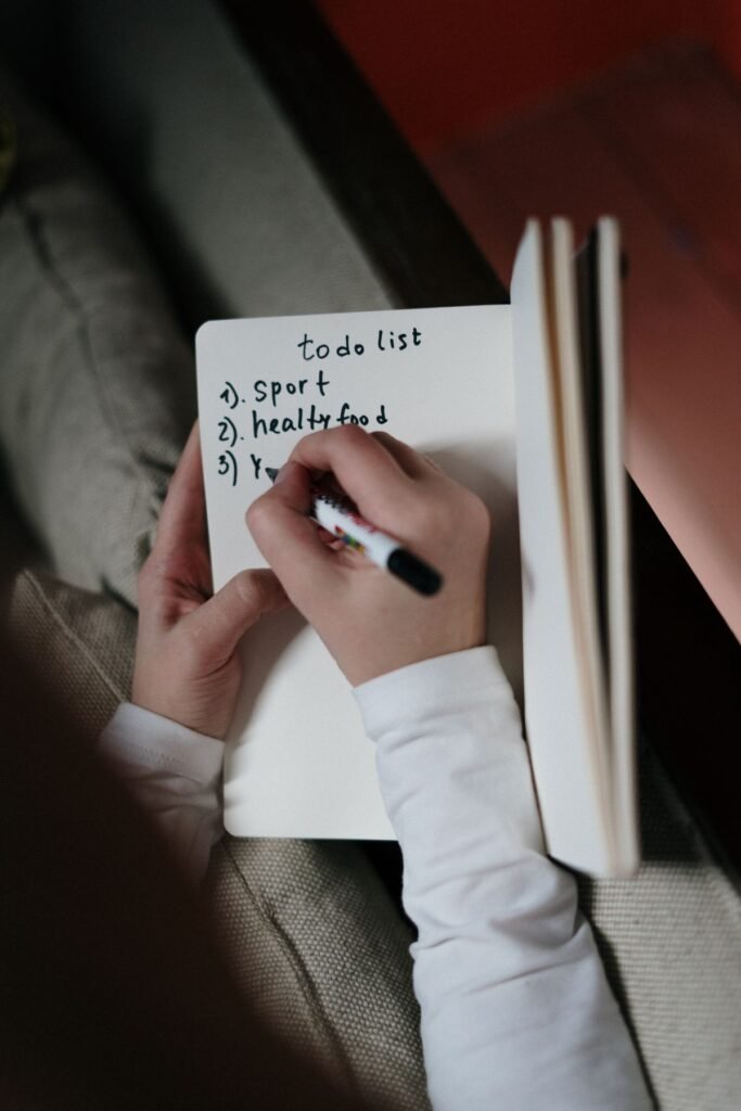 Person writing an entry in a diary