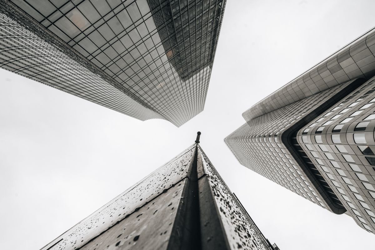Office buildings viewed from directly below, representing corporate headquarters and business structure