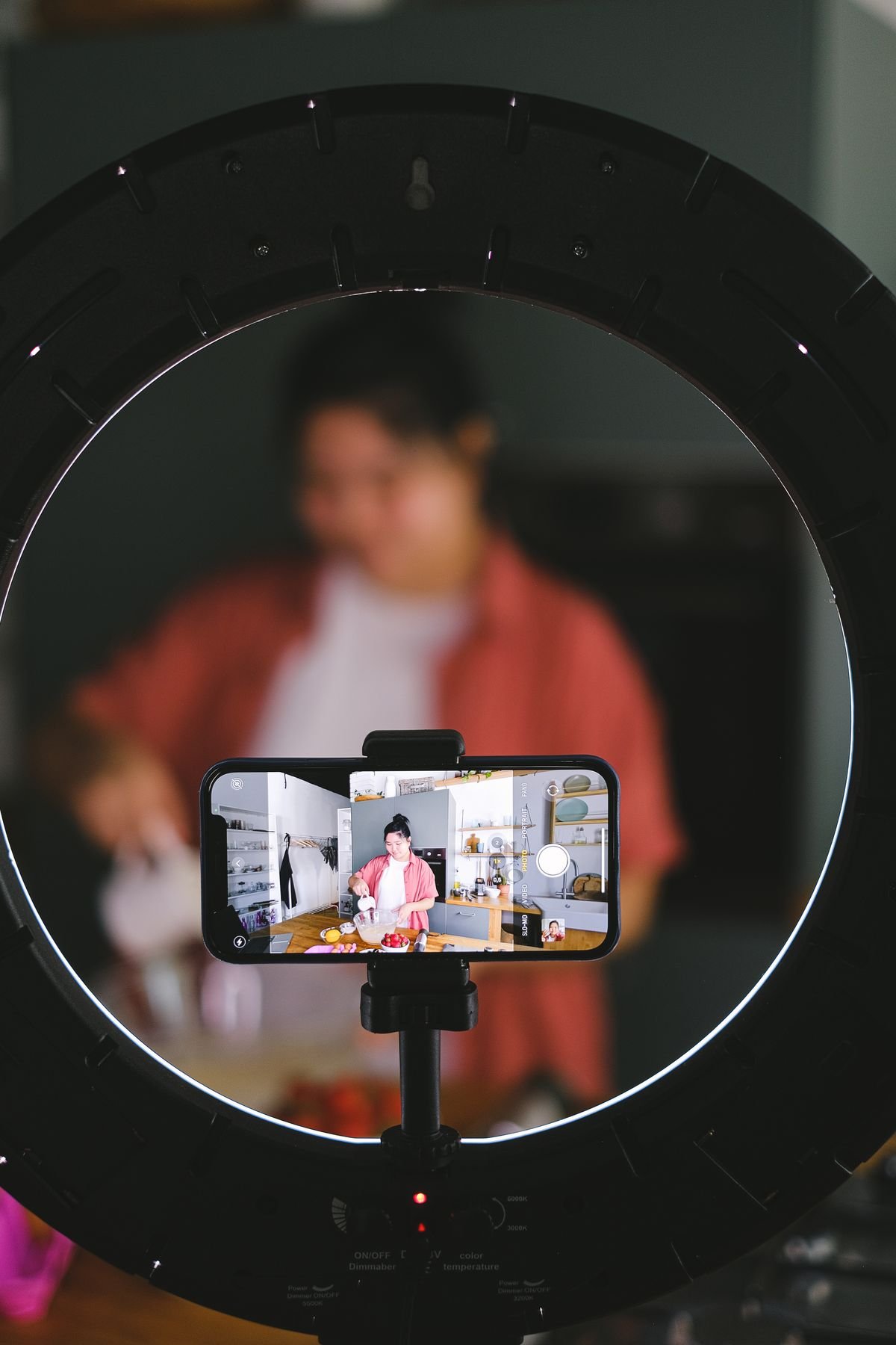 Phone on a tripod recording a person, representing content creation and live broadcasting
