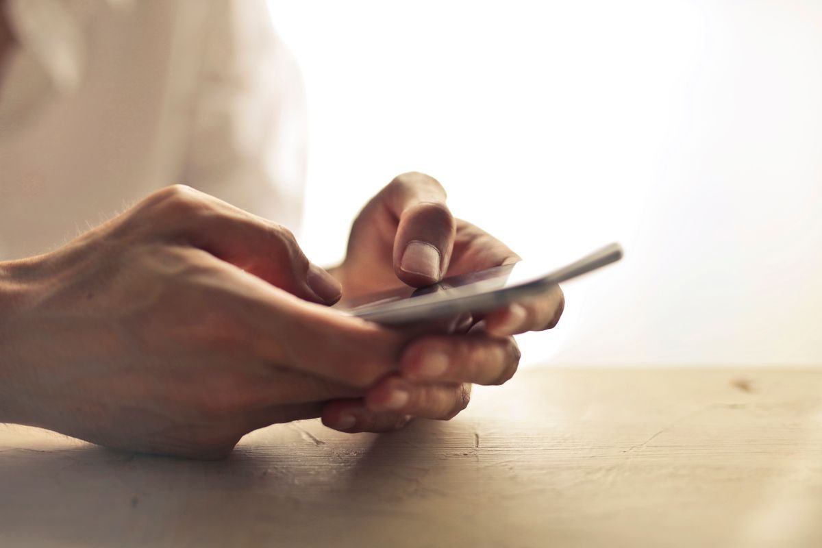 Close-up of a person using a smartphone to browse social media privately