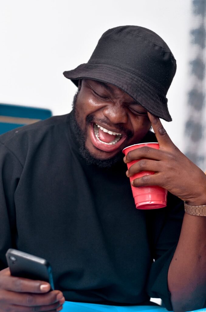 Man laughing while looking at his smartphone