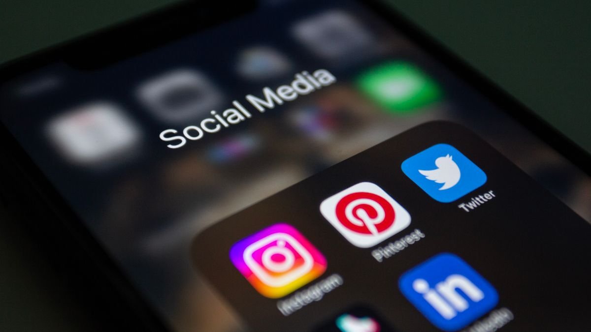 Close-up of a smartphone screen with a social media app folder, representing notification settings