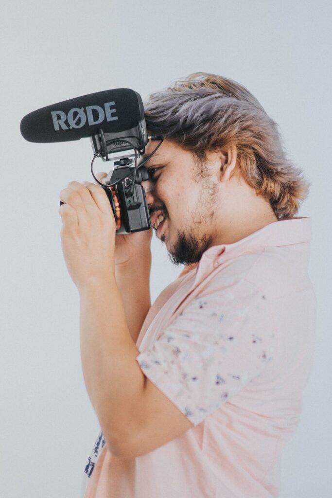 Man filming with a digital camera and external microphone