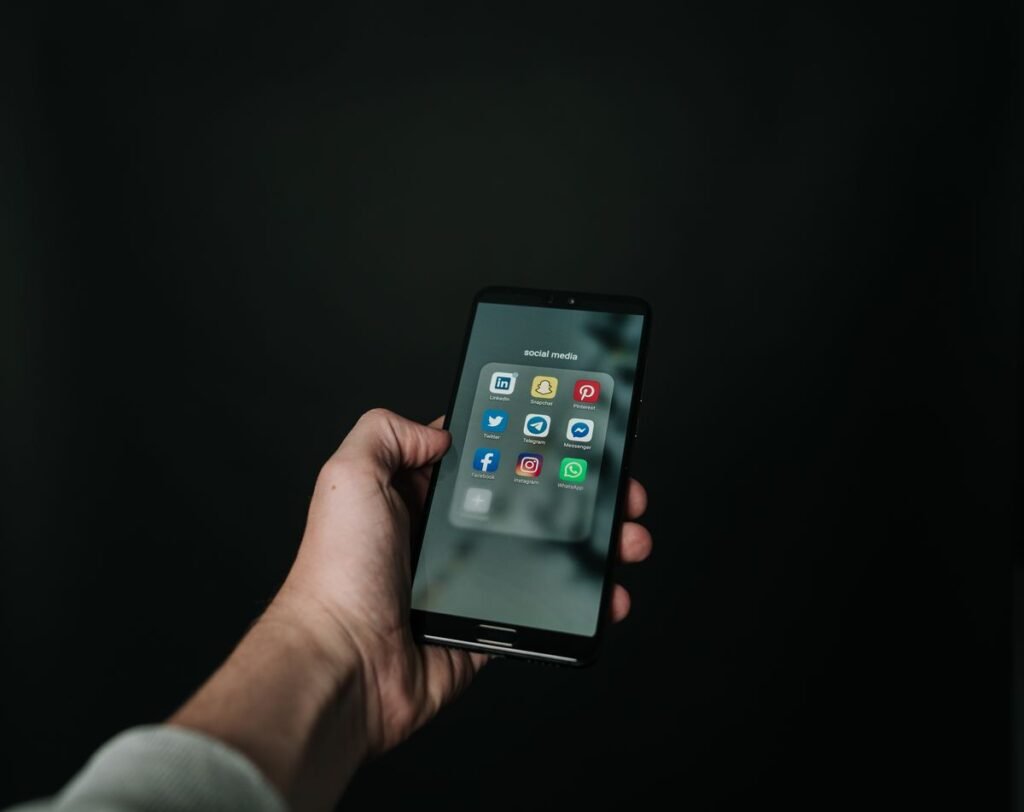 Hand holding a black smartphone