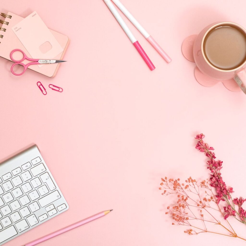 Pink minimalist flat lay with stationery and coffee