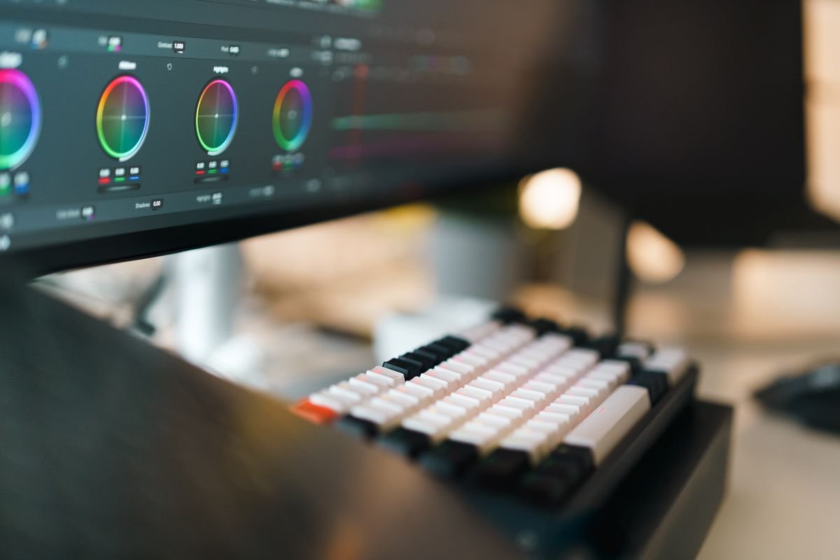 Professional video editing workspace with keyboard and monitor