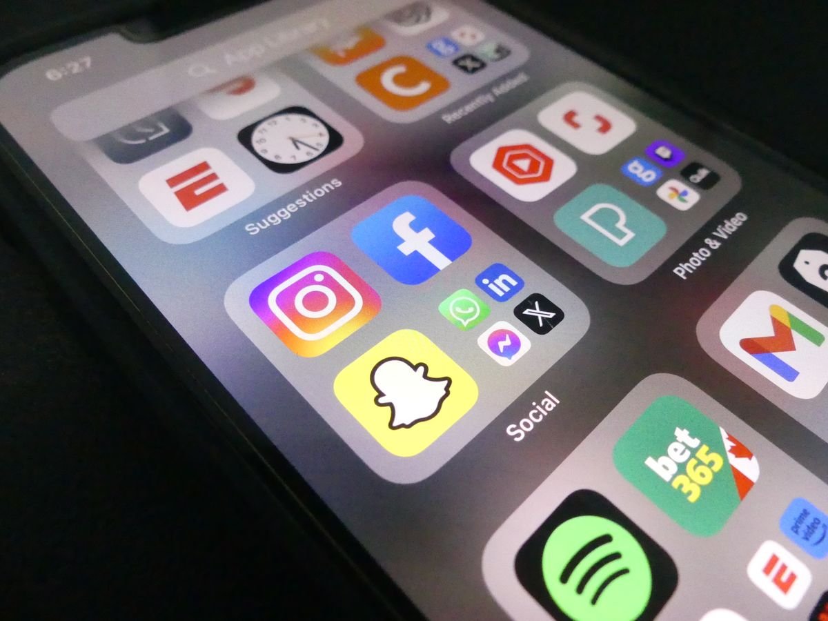 Smartphone display showing popular social media apps, representing in-app alerts