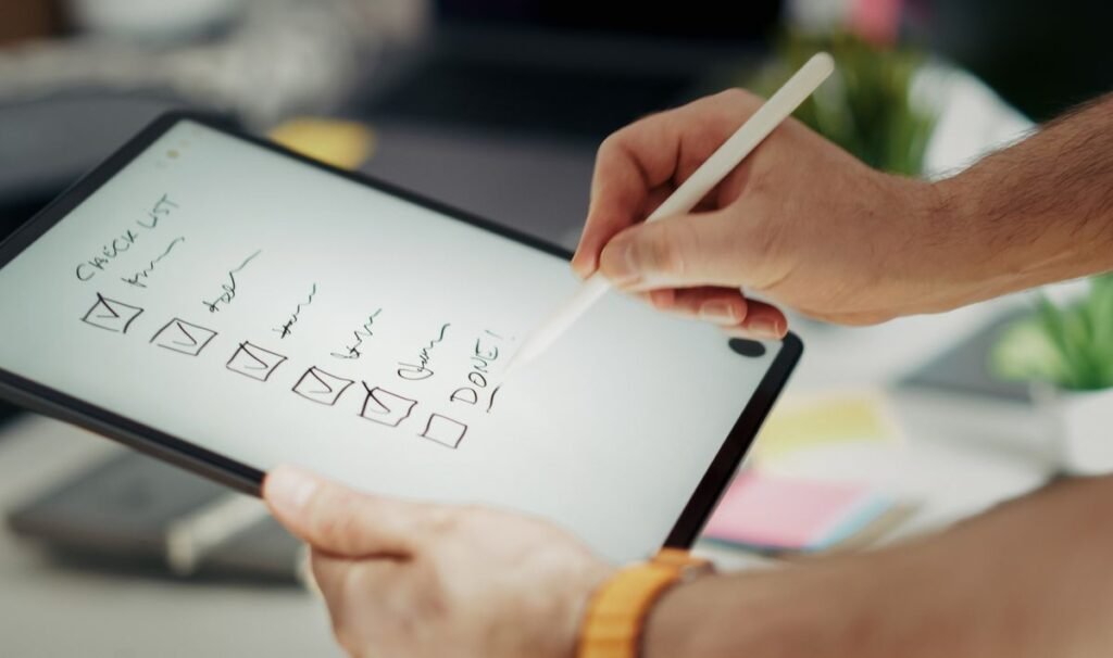 Person completing a digital checklist on a tablet representing compliance workflow