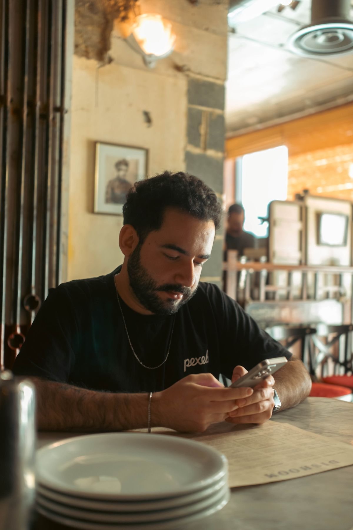 Dreamy, softly lit cafe scene with a phone on the table