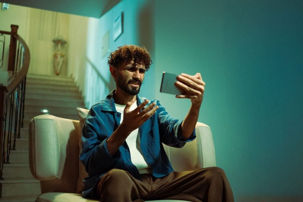 Confused person using a smartphone indoors, representing uncertainty over social media access