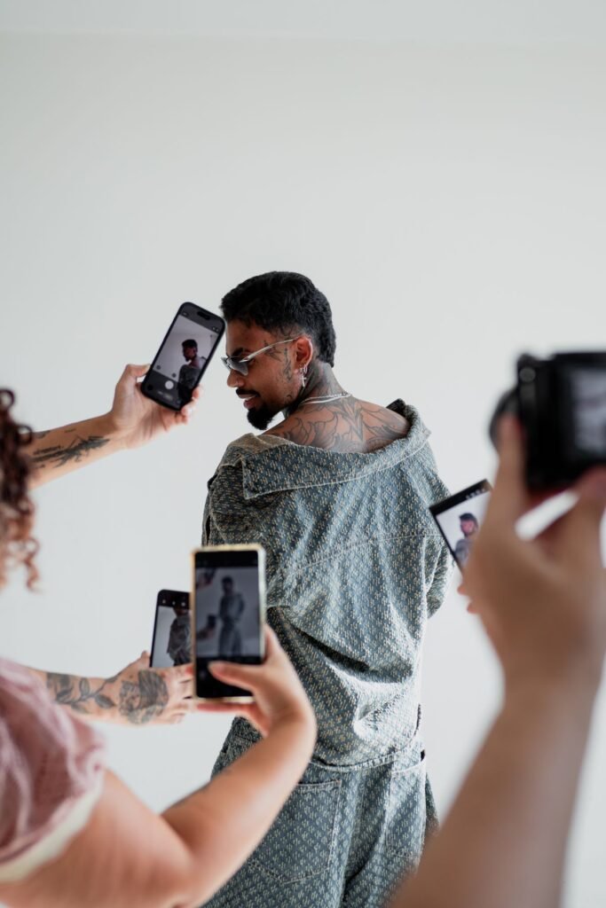 Man posing with multiple smartphones, content creation concept