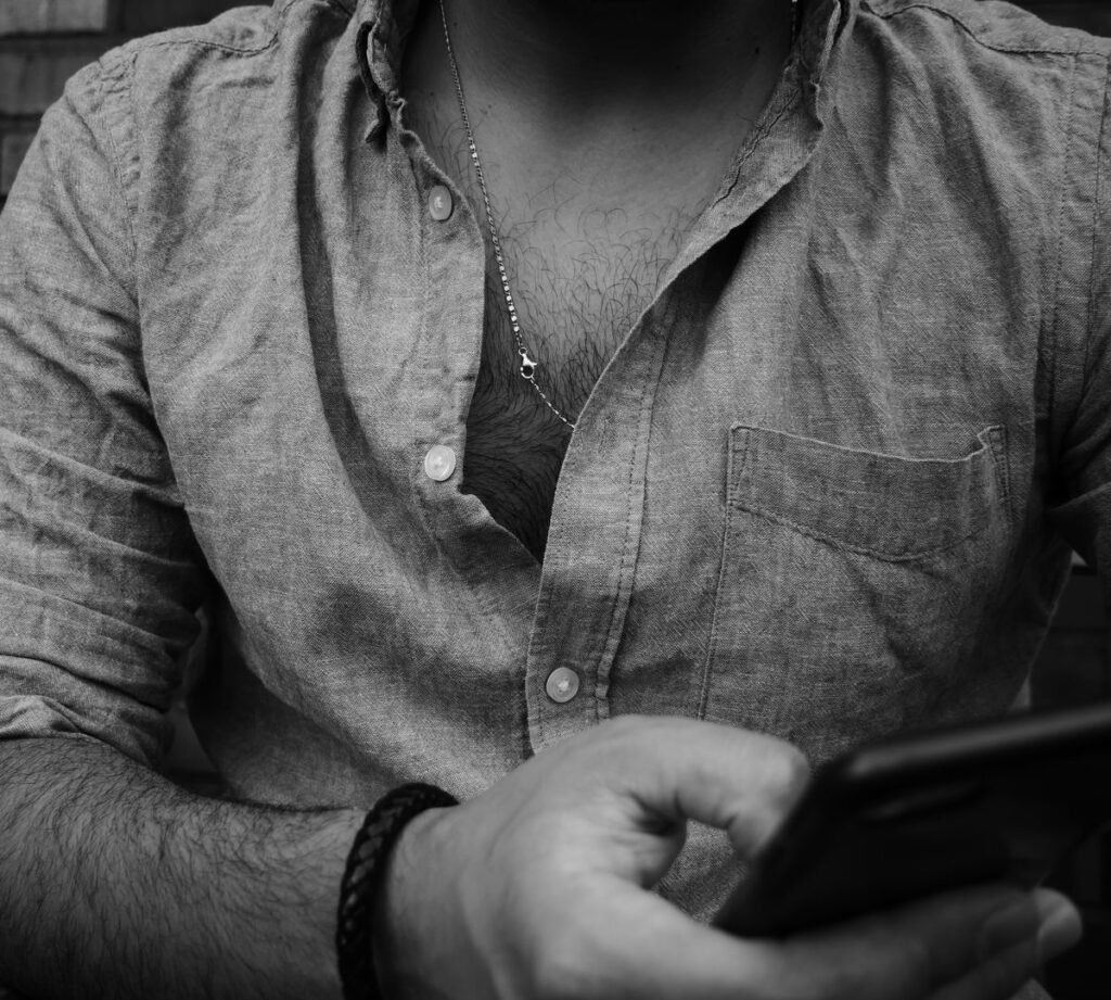 Man scrolling through photos on his phone