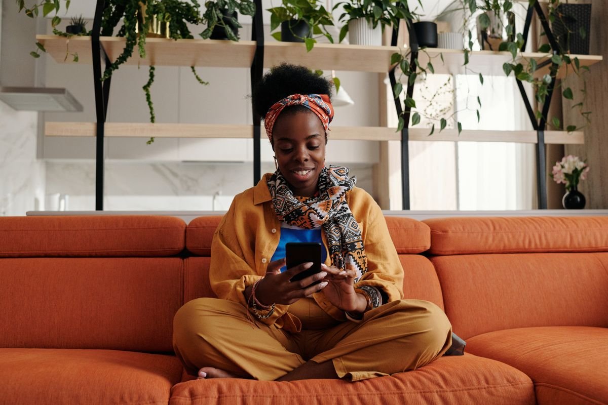 Woman smiling while looking at her phone