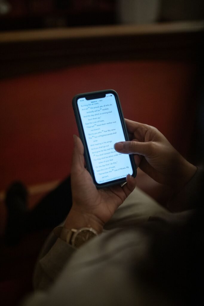 Close-up of a person looking at a phone screen in dim light