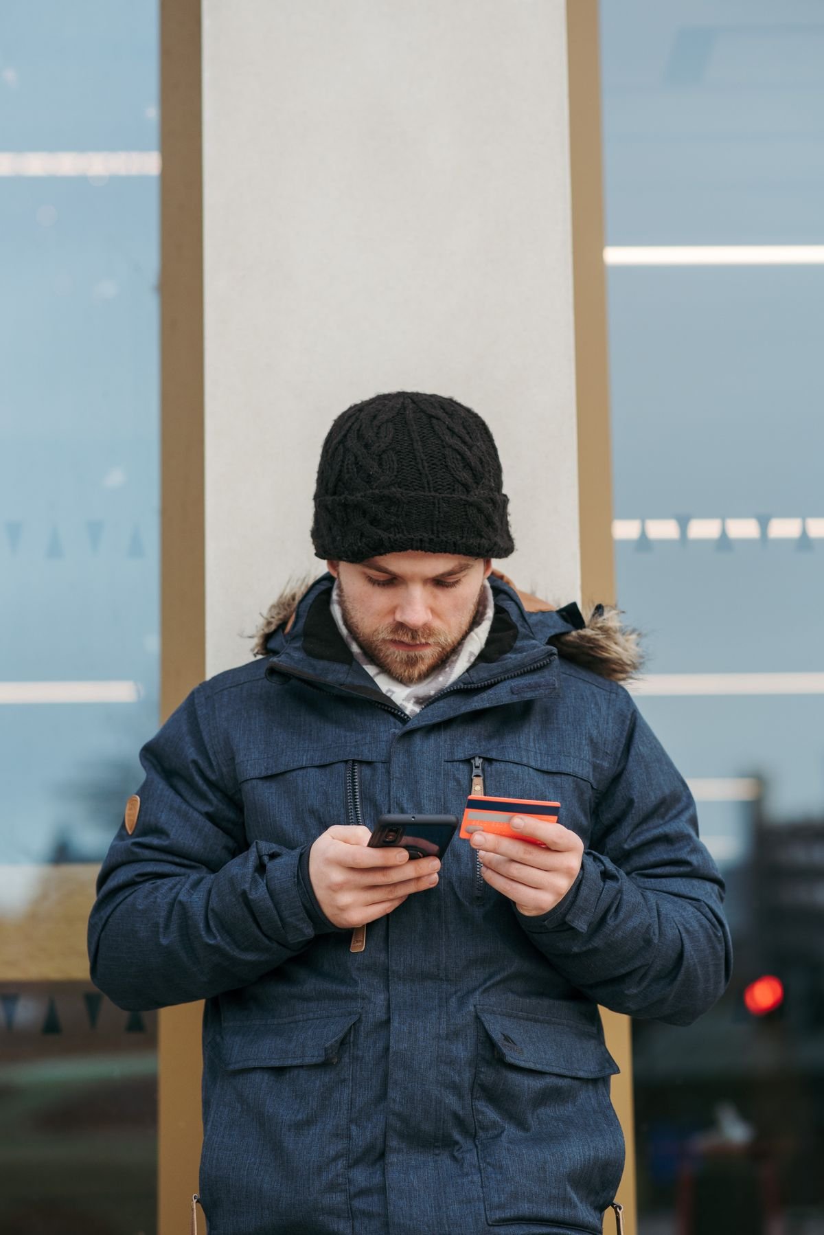 Young man making an online purchase with a smartphone and credit card