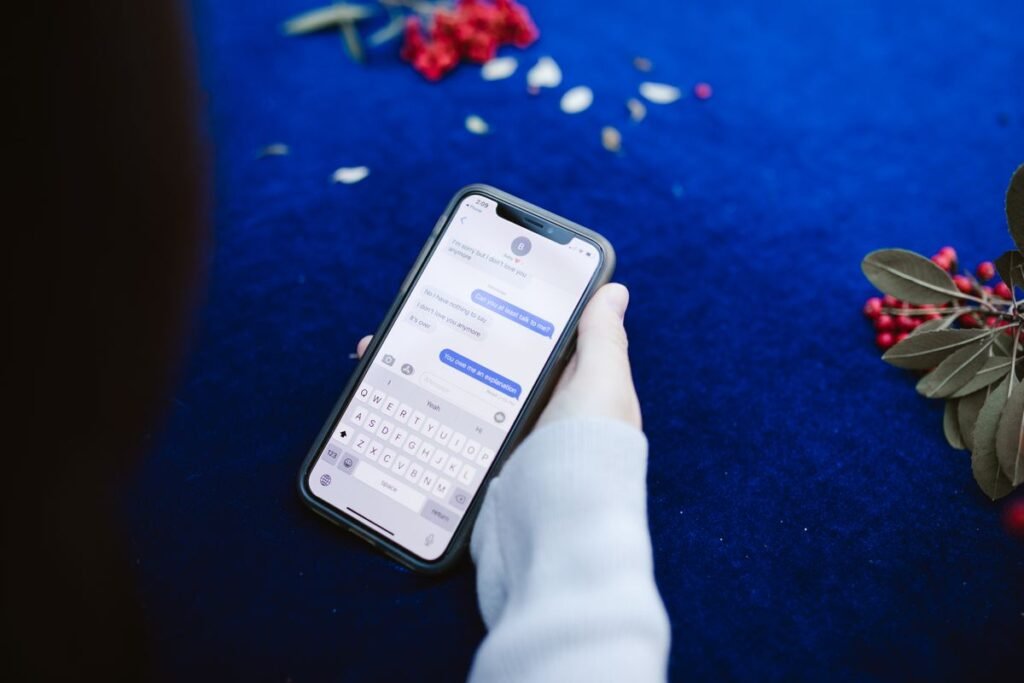 Person's hand showing text messages on a cellphone