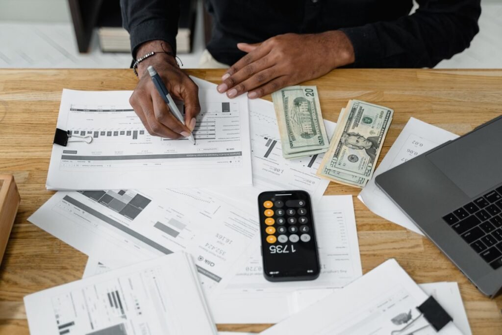 Auditor's workspace with laptop, calculator, and financial documents