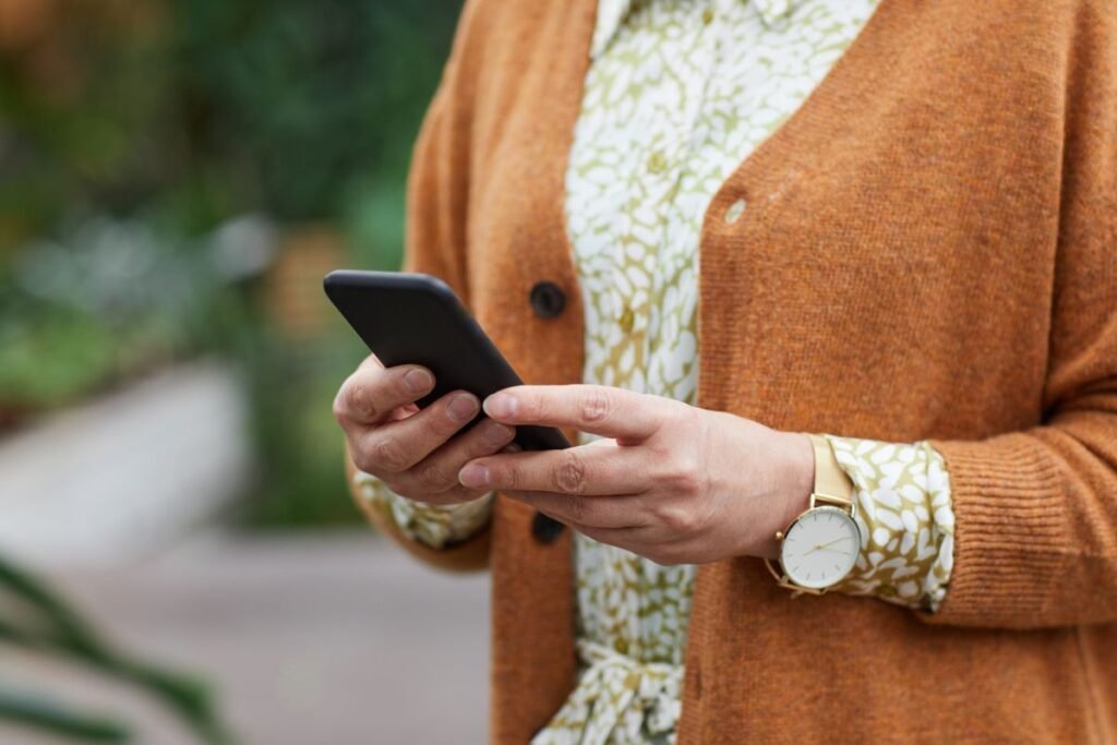 Person quietly browsing a smartphone, evoking discreet, anonymous social media viewing