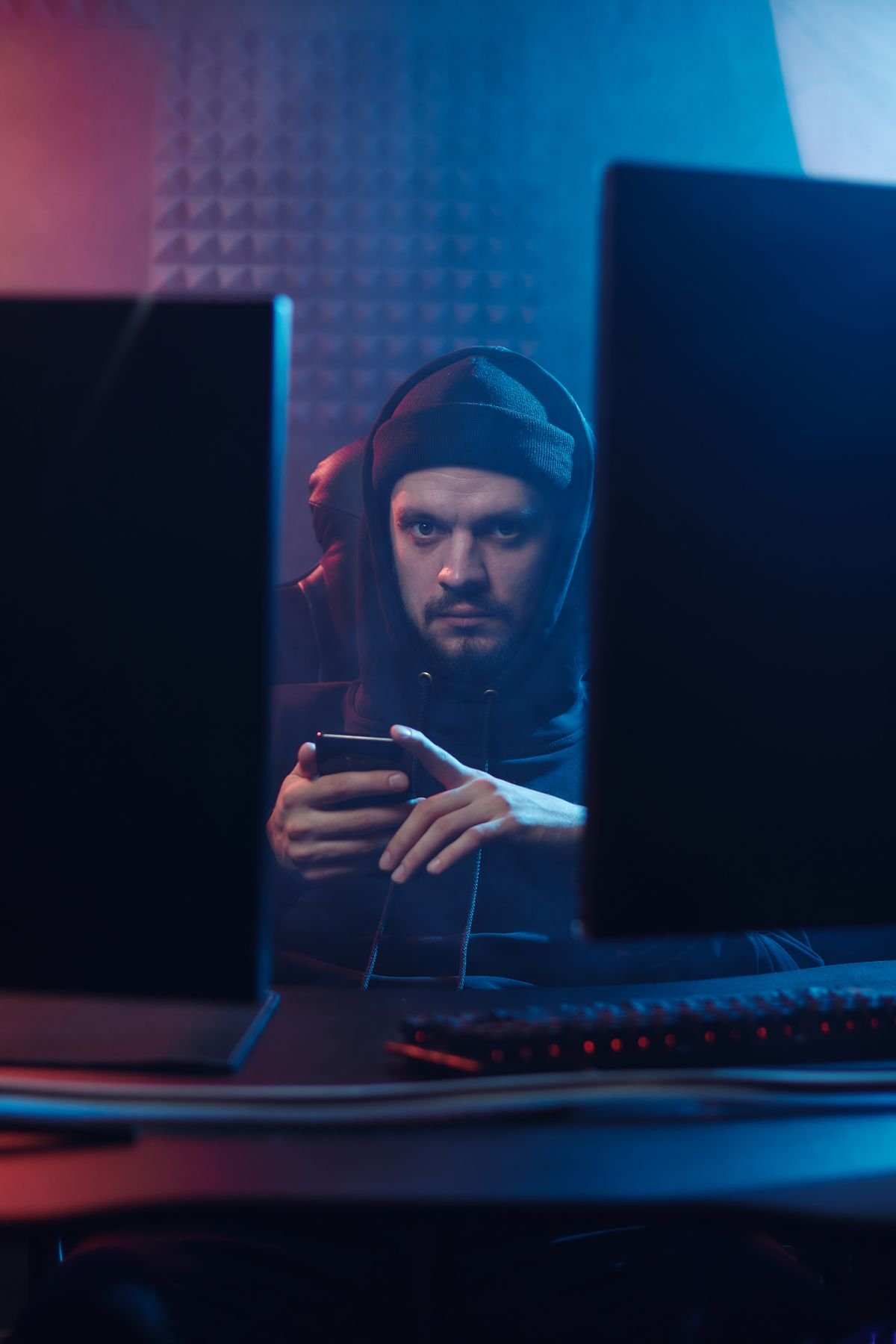 Person using a smartphone in a dark setting, evoking digital privacy and data protection