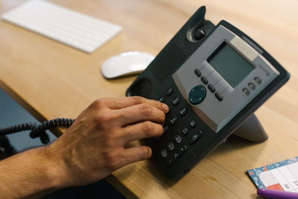Person dialing a number on a smartphone