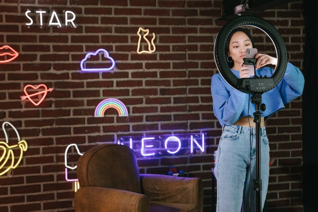 Young creator using her phone with a ring light
