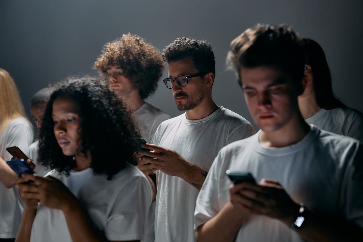 People using smartphones together, representing chatting and messaging on social apps