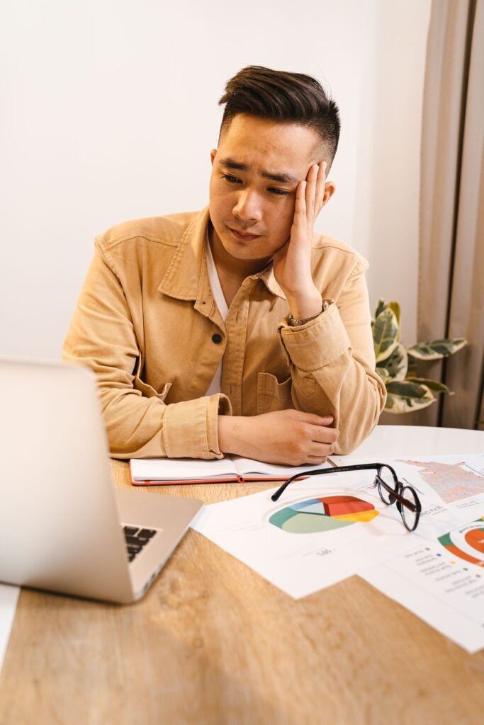 Frustrated man sitting at a laptop