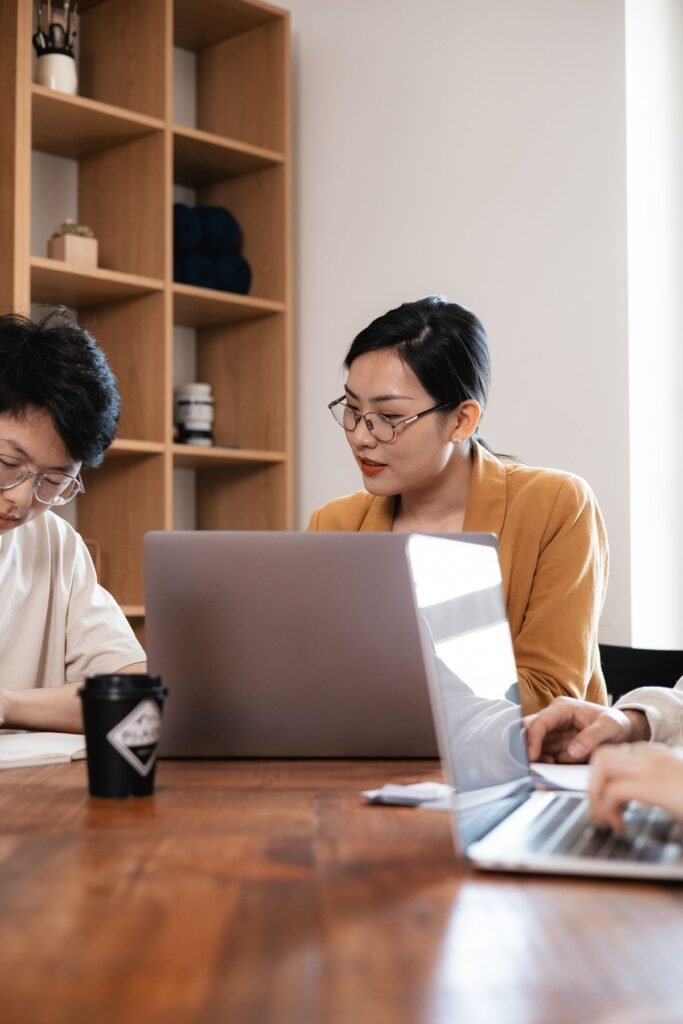 IT and security team members working together on laptops in an office
